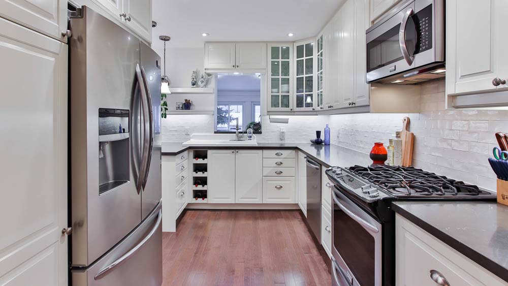 A kitchen with all new stainless steel appliances