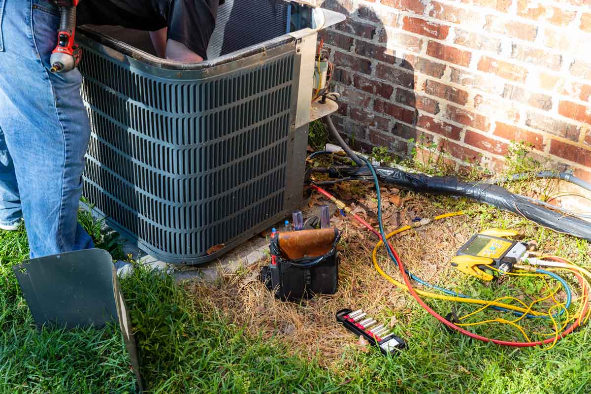 Close-up shot of technician working on AC unit